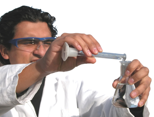 Photo of a chemist pouring from a graduated cylinder into a flask